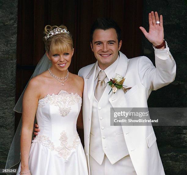 Westlife singer Shane Filan poses with his new wife Gillian Walsh outside Ballintubber Abbey December 28, 2003 in County Mayo, Ireland.