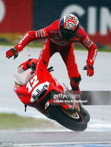 Troy Bayliss of Australia and the Ducati Marlboro team falls off his bike during the warm up session for the Skyy Vodka Australian Motorcycle Grand...