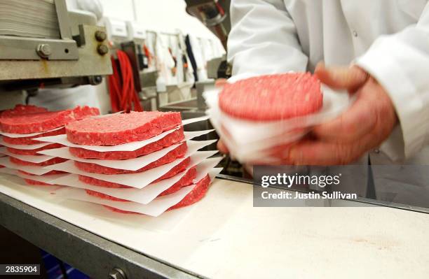 Eliseo Araujo removes ground beef patties from a conveyor belt at Ray's Wholesale Meats December 29 in Yakima, Washington. U.S. Agriculture officials...