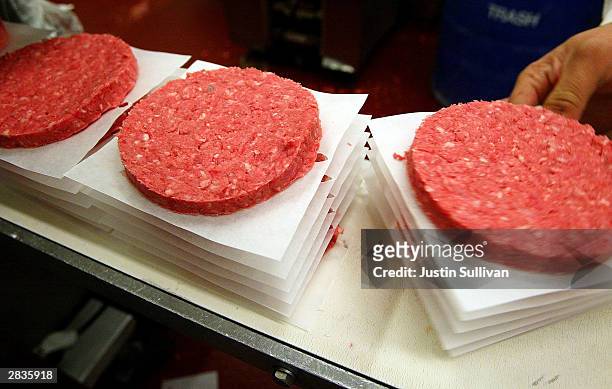 Eliseo Araujo removes ground beef patties from a conveyor belt at Ray's Wholesale Meats December 29 in Yakima, Washington. U.S. Agriculture officials...