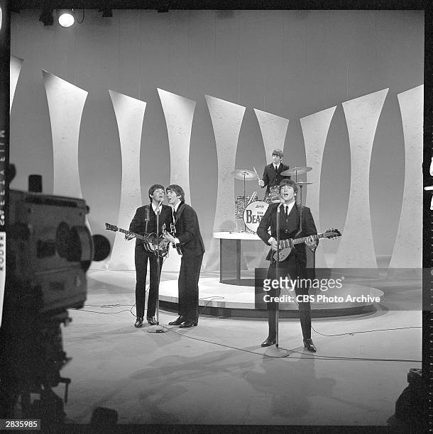 View of the members of British Rock group the Beatles as they perform onstage for 'The Ed Sullivan Show' at CBS's Studio 50, New York, New York,...