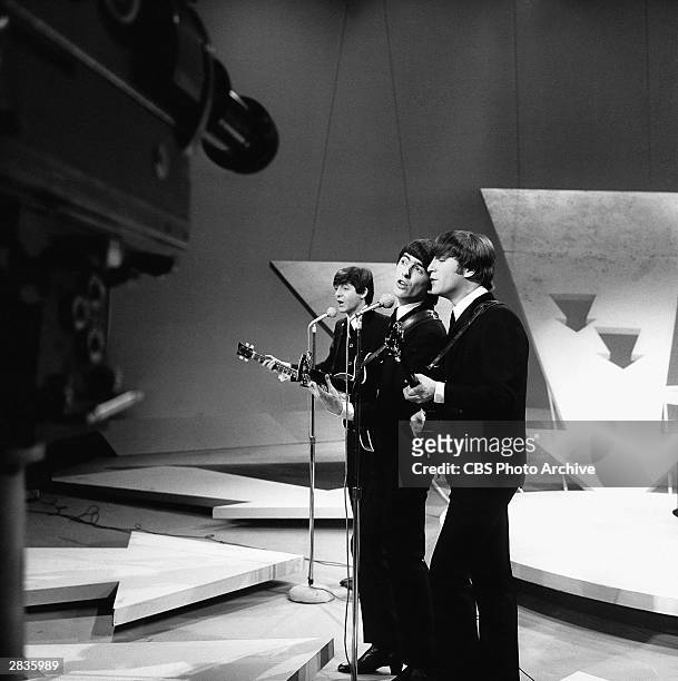From left, British Rock musicians Paul McCartney, George Harrison, and John Lennon, all of the group the Beatles, perform onstage during their debut...