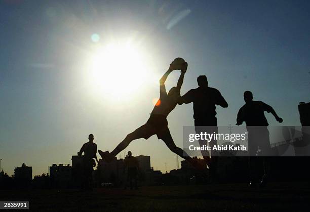 Palestinian soccer players fight for the ball during a soccer match December 29, 2003 in Gaza City, Gaza Strip. This is the final game of the Gaza...