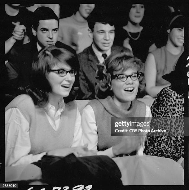 View of audience members during a performance, by the Beatles, on the 'The Ed Sullivan Show' at CBS's Studio 50, New York, New York, February 9, 1964.