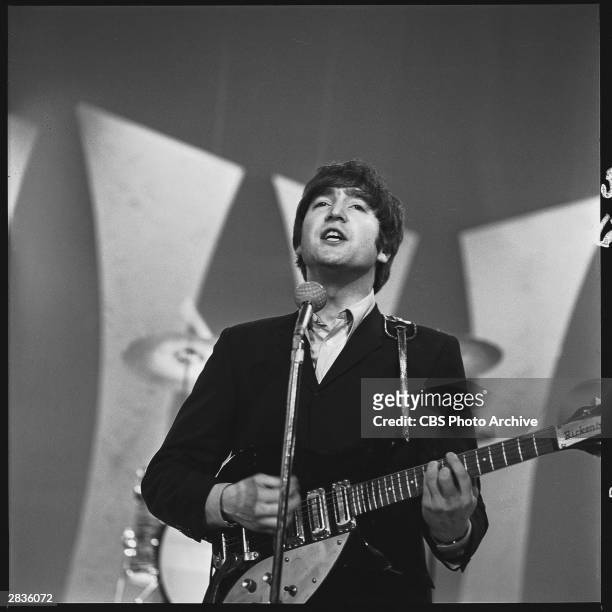 British Rock musician John Lennon, of group the Beatles, performs onstage for 'The Ed Sullivan Show' at CBS's Studio 50, New York, New York, February...
