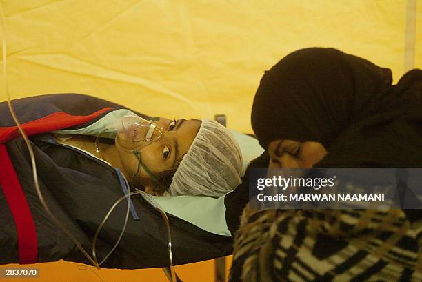 An Iranian girl, who was rescued after spending four day under the rubble following a deadly earthquake that hit the southeastern city of Bam,...