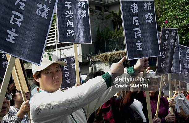 Man points to a placard while protesting against the Japan Interchange Association for interfering with Taiwan's interior policy in Taipei, 31...