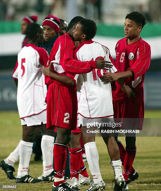 Oman's Mohammed Rabee and Hamdi Hobis are congratulated by Emirati forward Ismail Matar at the end of their Gulf Cup tournament match in Kuwait City...