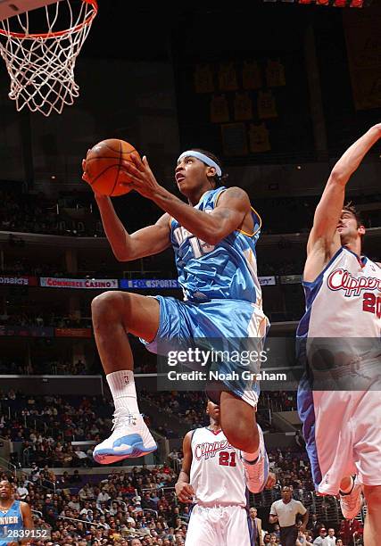 Carmelo Anthony of the Denver Nuggets goes hard to the hoop past Marko Jaric of the Los Angeles Clippers on December 31, 2003 at the Staples Center...