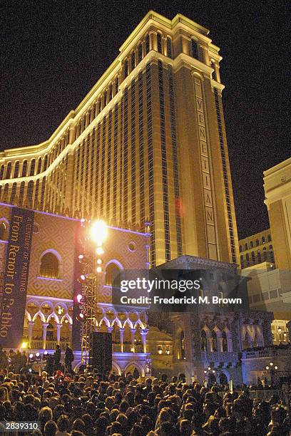 Crowds of people gather in front of the Venetian Resort-Hotel-Casino on New Year's Eve for the "America's Party" to celebrate the approach of the New...