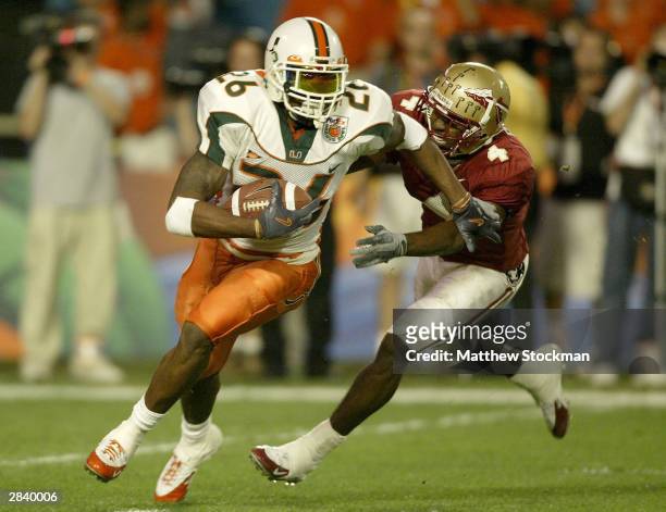 Sean Taylor of the Miami Hurricanes tries to elude P.K. Sam of the Florida State Seminoles after making an interception during the Orange Bowl...