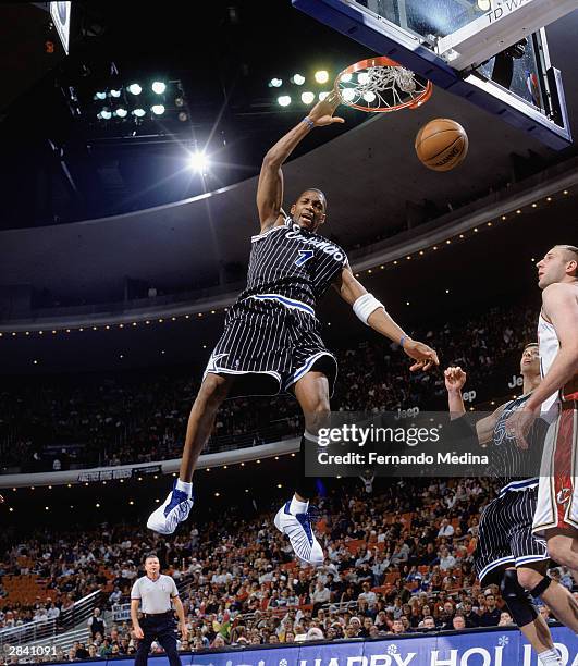 Tracy McGrady of the Orlando Magic follows through on his slam dunk against the Cleveland Cavaliers during the game on December 25, 2003 at TD...