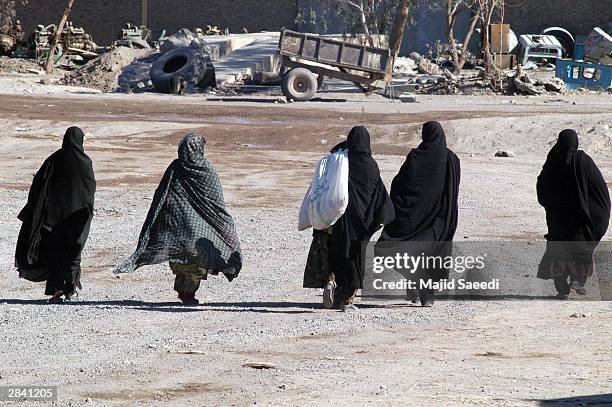 Group of Iranian woman walk down the street January 2, 2003 in Bam, Iran. A week after a massive earthquake shattered Bam, killing some 30,000...