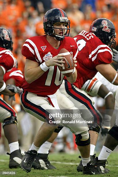 Eli Manning of the Mississippi Rebels drops back to pass against the Oklahoma State Cowboys during the SBC Cotton Bowl on January 2, 2004 in Dallas,...