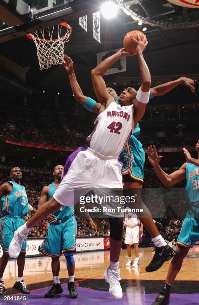 Donyell Marshall of the Toronto Raptors attempts the shot under the hoop against Stacey Augmon of the New Orleans Hornets on January 2, 2004 at the...