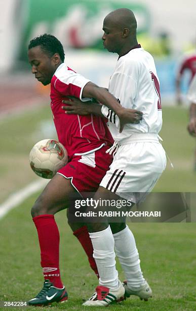 Emirati Ismail Matar vies with Qatar's Salman al-Maamari during their Gulf Cup tournament match in Kuwait City 03 January 2004. The match ended with...