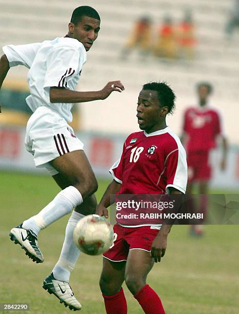 Emirati Ismail Matar vies with Qatar's Jaffal Rashed during their Gulf Cup tournament match in Kuwait City 03 January 2004. The match ended with a...