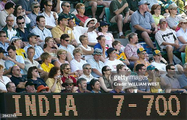 Sydney cricket spectators sit quietly as the Indian total passes 700 runs on the third day of the fourth Test Match in Sydney 04 January 2004. After...