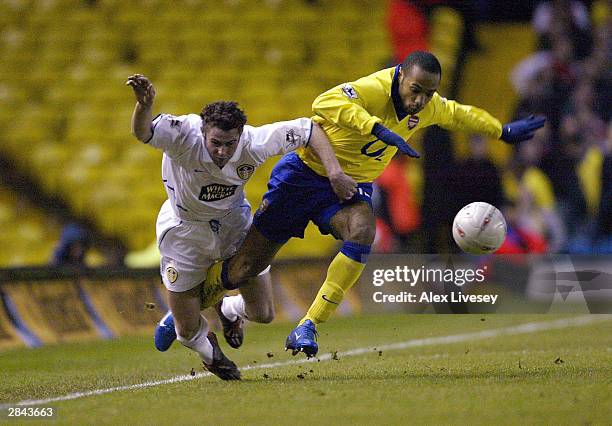 Thierry Henry of Arsenal holds off Frazer Richardson of Leeds during the FA Cup Third round match between Leeds United and Arsenal at Elland Road,...