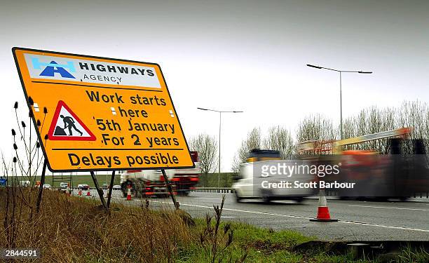 Cars drive past a sign on the M25 motorway informing them of road works due to the widening of the M25 on January 5, 2004 in London. The two-year...