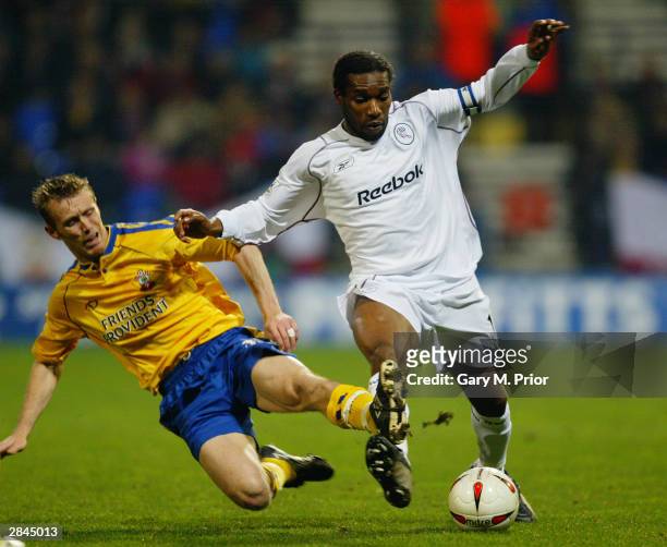 Jay Jay Okocha of Bolton Wanderers is tackled by Brett Ormerod of Southampton during the Carling Cup Quarter Final match between Bolton Wanderers and...