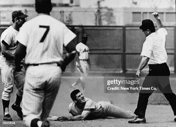 Cincinnati Reds third baseman Pete Rose looks up after being called out at second base by umpire Bob Burkhart in a game against the New York Mets at...