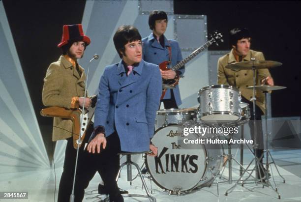 The Kinks, Dave Davies, Ray Davies, Peter Quaife, and Mick Avory, wait on the set of a television show, ready to perform, 1968.