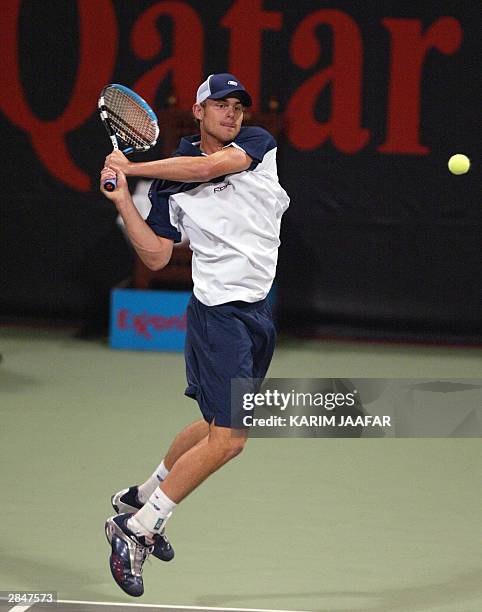 World number one and top seed Andy Roddick of the US returns the ball to Nikolay Davydenko of Russia during their game at the ATP Qatar Open in Doha...