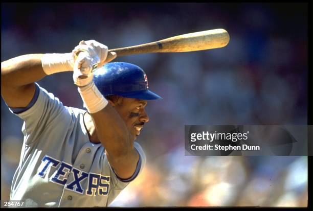 JULIO FRANCO OF THE TEXAS RANGERS IN HIS WELL-KNOWN, BAT-OVER-THE-HEAD BATTING STANCE DURING THEIR GAME AGAINST THE CALIFORNIA ANGELS AT ANAHEIM...
