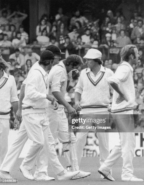 England players gather around Rick McCosker of Australia after getting hit in the face during the Centenary Test between Australia and England at the...