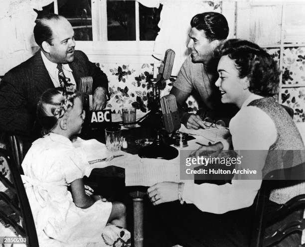 American radio personality Ted Malone eats breakfast with American actor and politician Ronald Reagan and his family, American actor Jane Wyman and...
