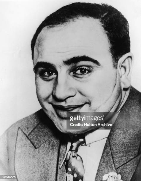 American gangster Al Capone poses for a portrait, showing off the scar that earned him his nickname, circa 1920s.