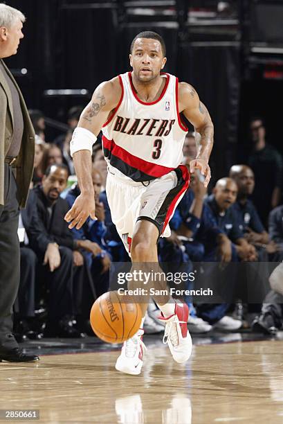 Damon Stoudamire of the Portland Trail Blazers moves the ball up court during the game against the Dallas Mavericks at the Rose Garden on December...