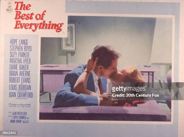 Lobby card depists a passionate kiss between Irish actor Stephen Boyd and American actor Hope Lange in a scene from 'The Best Of Everything,'...