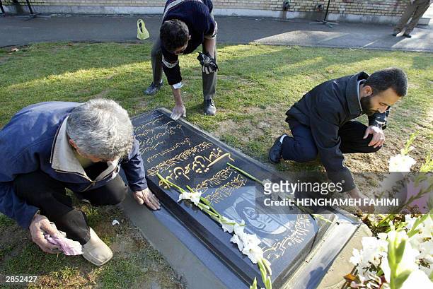 Member of the "global committee for the martyrs of Islam" add the finishing touches to a newly laid tombstone to honour Khaled Eslamboli, the...