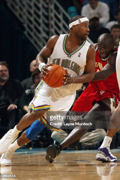 Baron Davis of the New Orleans Hornets drives against the Atlanta Hawks during the game at New Orleans Arena on December 26, 2003 in New Orleans,...
