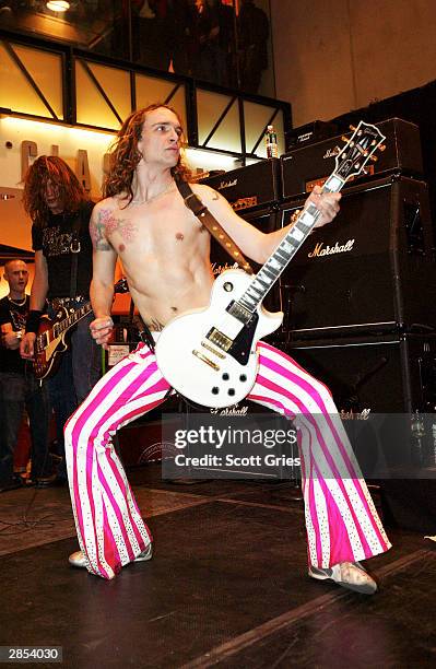The Darkness lead singer, Justin Hawkins, performs at the Virgin Megastore Times Square January 08, 2004 in New York City.