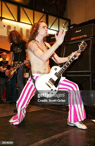 The Darkness lead singer, Justin Hawkins, gestures as he performs at the Virgin Megastore Times Square January 08, 2004 in New York City.