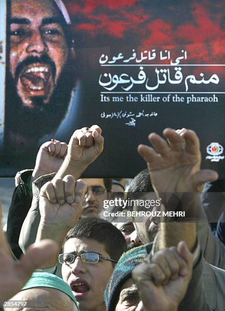 Iranian hardliners hold up a portrait of Khaled Eslamboli, the assassin of former Egyptian president Anwar Sadat, killed in 1981 during a military...