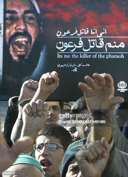 Iranian hardliners hold up a portrait of Khaled Eslamboli, the assassin of former Egyptian president Anwar Sadat, killed in 1981 during a military...
