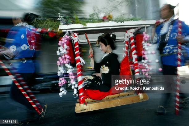 Maiko and Geiko make their way to work, January 9, 2004 to attend a New Year's ceremony in Kyoto, Japan. As the struggling Japanese economy has...