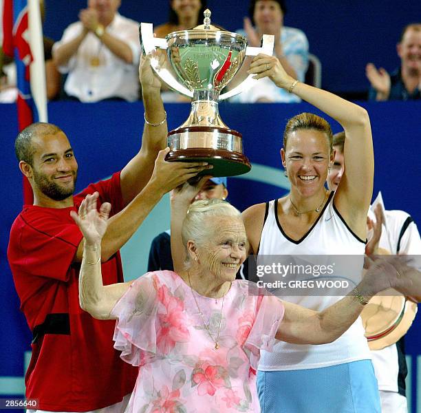 James Blake and compatriot Lindsay Davenport of the US, joke with Lucy Hopman , wife of the late Harry Hopman, at the trophy presentation after they...