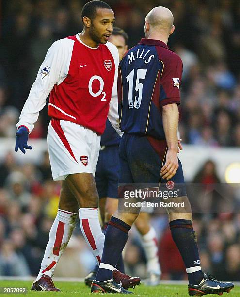 Danny Mills of Middlesbrough disputes the penalty that Arsenal were awarded with Thierry Henry of Arsenal during the FA Barclaycard Premiership match...