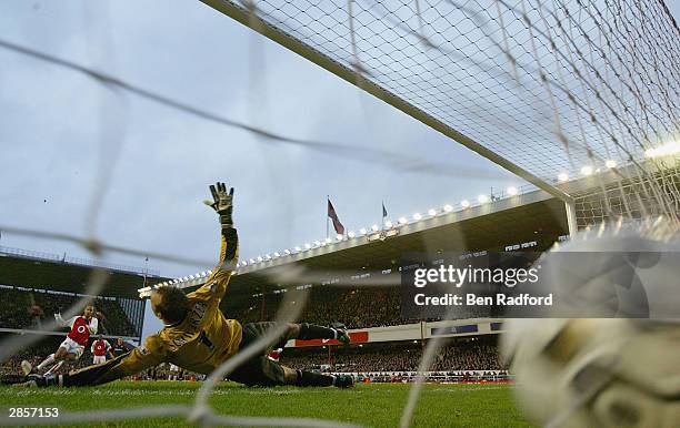 Thierry Henry of Arsenal scores the first goal for Arsenal from the penalty spot during the FA Barclaycard Premiership match between Arsenal and...