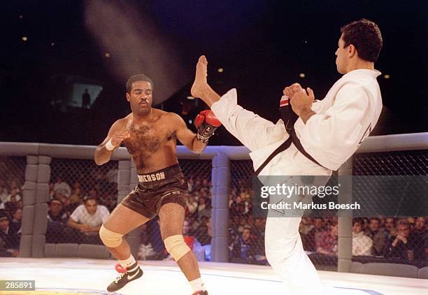 Jiu-Jitsu black belt Royce Gracie kicks at cruiserweight boxer Art Jimmerson during a 1st round match in the Ultimate Fighter Championships in...