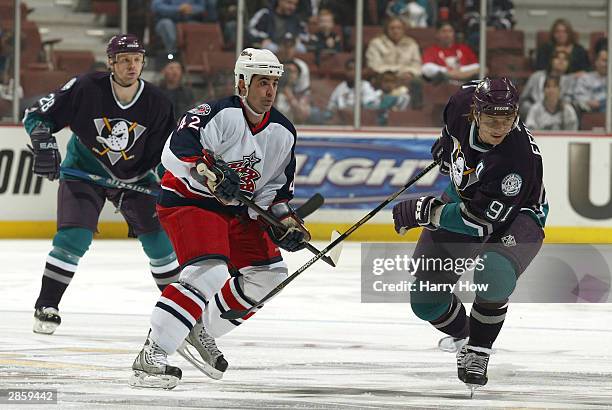 Mark Hartigan of the Columbus Blue Jackets checks Sergei Fedorov of the Anaheim Mighty Ducks in the first period during a game on January 11, 2003 at...