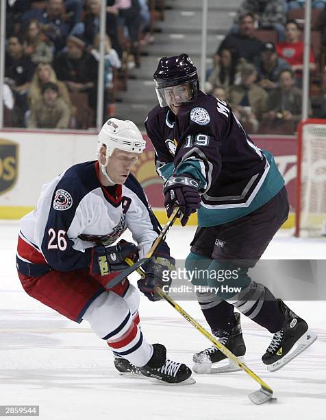 Todd Marchant of the Columbus Blue Jakets is checked by Andy McDonald of the Anaheim Mighty Ducks in the second period during the game on January 11,...