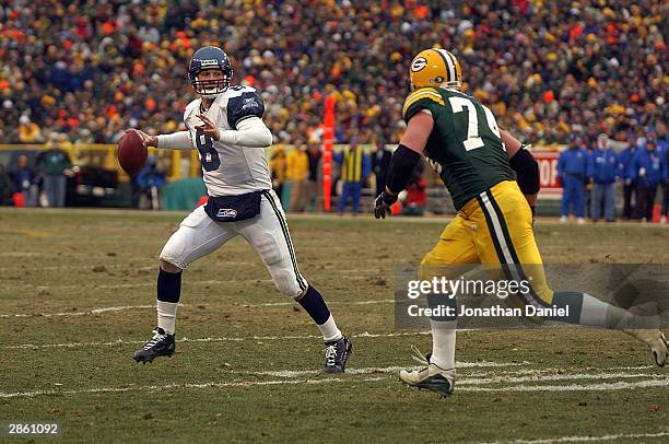Quarterback Matt Hasselbeck of the Seattle Seahawks scrambles in the NFC Playoff game as Aaron Kampman of the Green Bay Packers tries to sack him on...