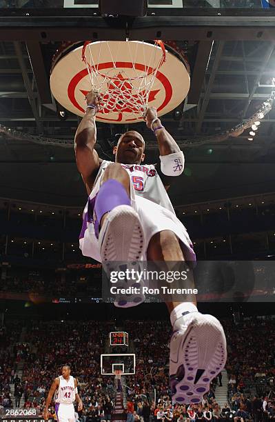 Vince Carter of the Toronto Raptors hangs on the net during the game against the New Orleans Hornets at the Air Canada Centre on January 2, 2004 in...