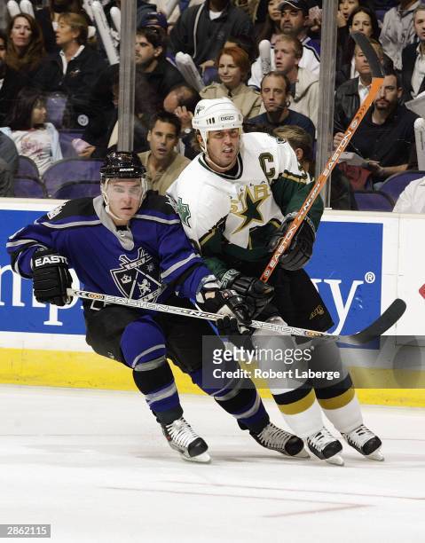 Mike Modano of the Dallas Stars vies for position with Michael Cammalleri of the Los Angeles Kings during the game on December 4, 2003 at Staples...